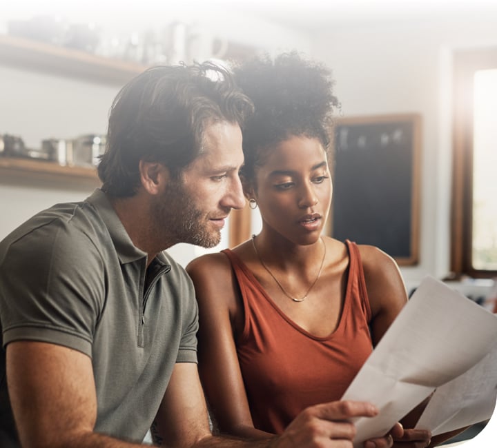 Woman showing man insurance paperwork